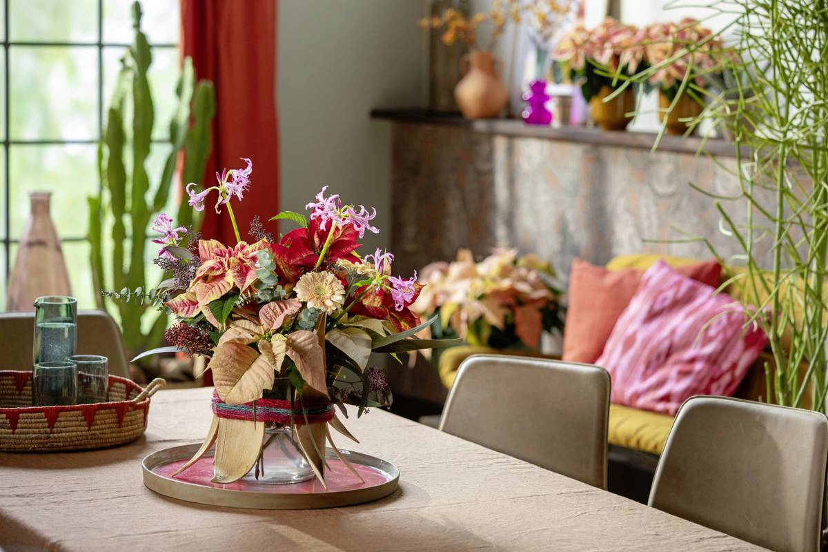home floral centerpieces in a rustic ceramic bowl with eucalyptus, white roses, and seasonal greenery